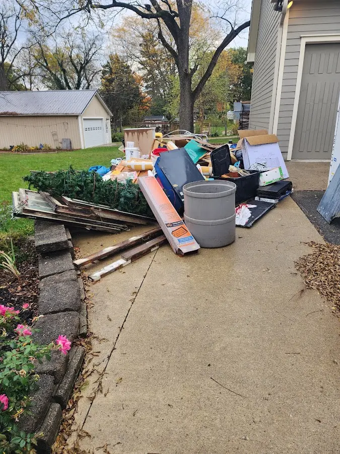 Dumpster being loaded with debris for 12 Yard Dumpster Rental in Robstown